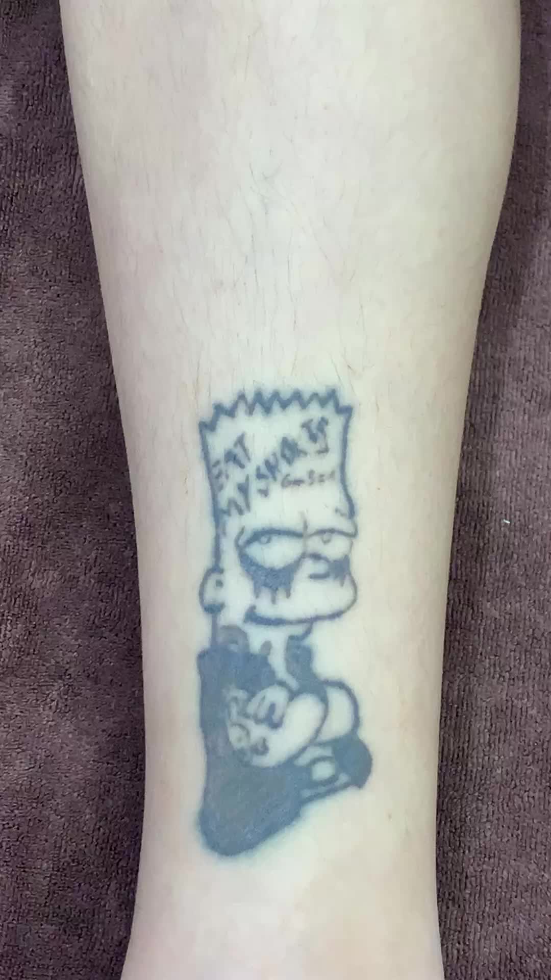 Bart Simpson tattoo on the tricep